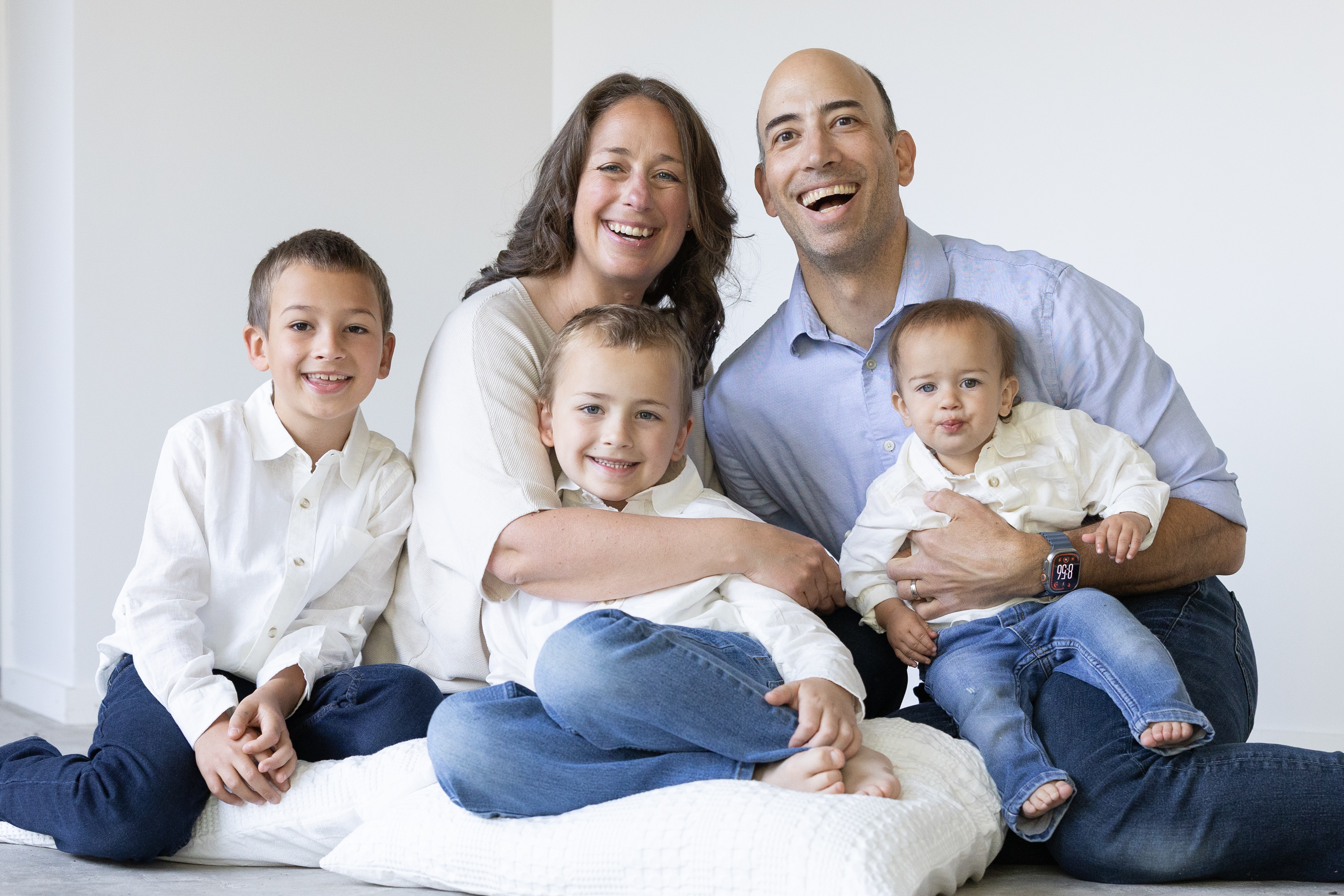 Liz, Ryan, and their three sons smiling together