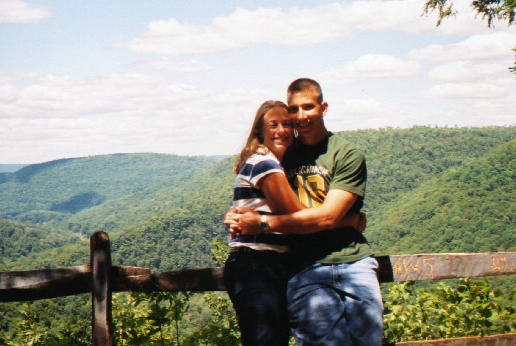 Liz and Ryan hugging at a mountain overlook
