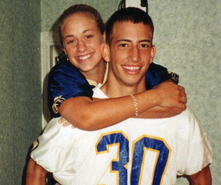 Liz on Ryan's back in football jerseys