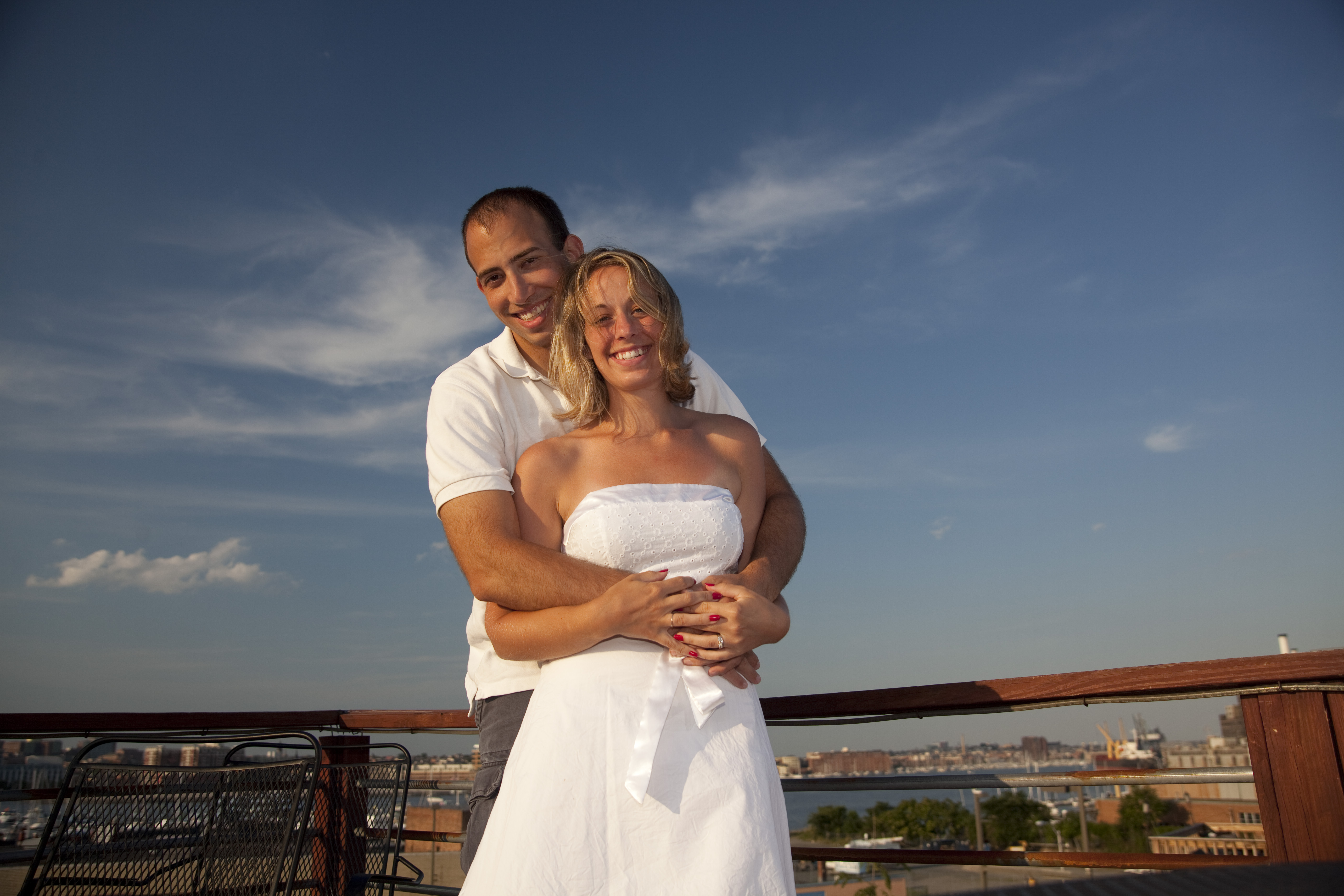 Liz and Ryan on a rooftop with the Baltimore skyline behind them