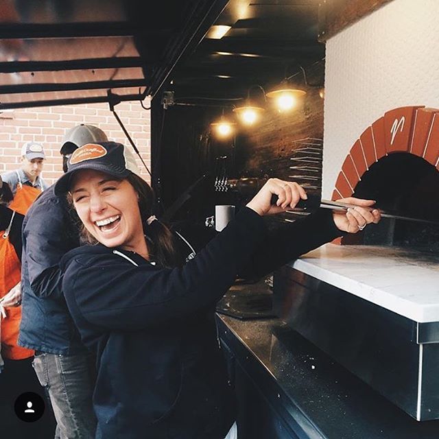 Liz laughing while making pizza in the food truck