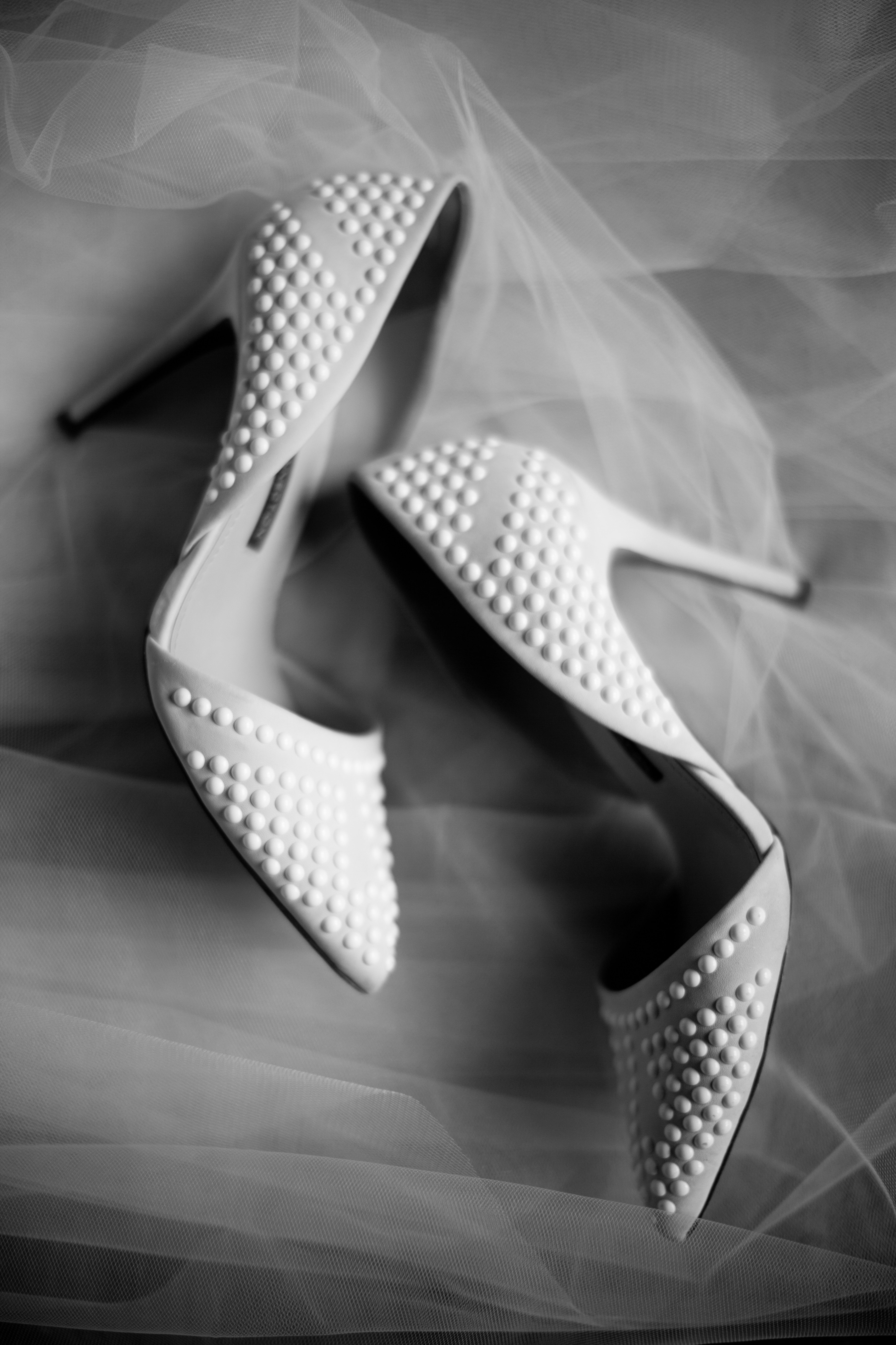 Pearl bridal heels on a wedding veil