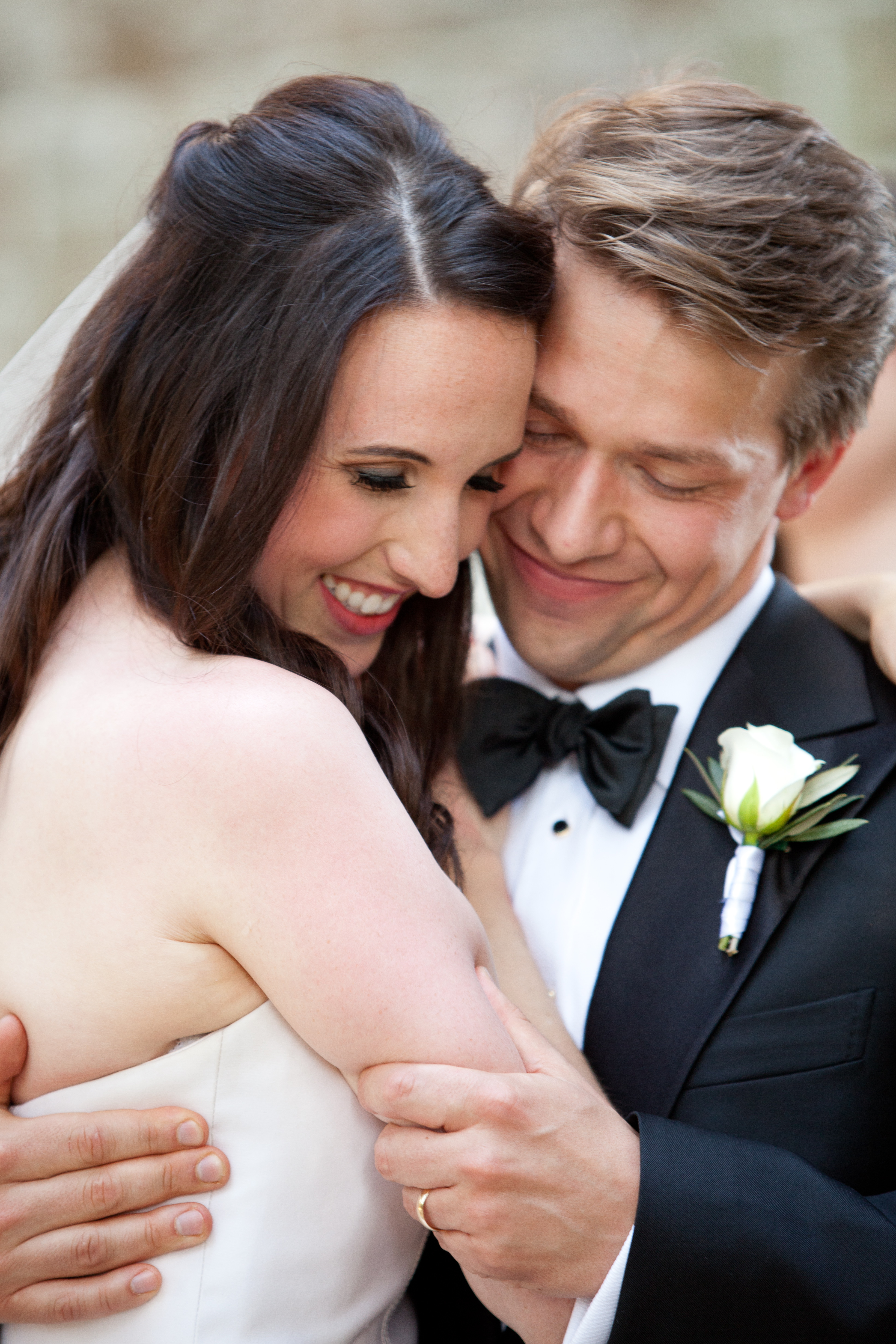 Close-up of bride and groom embracing