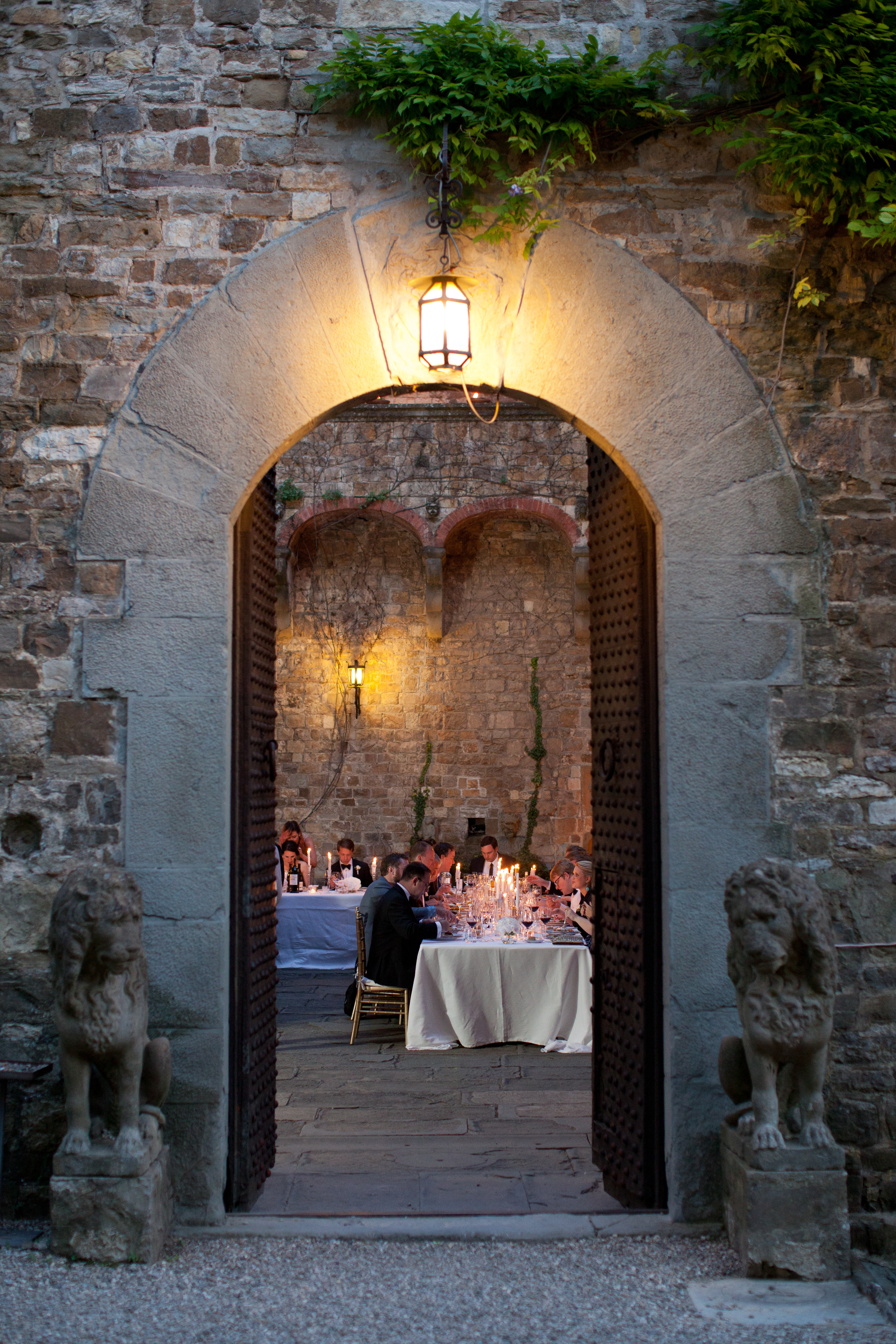 Wedding dinner through a stone archway